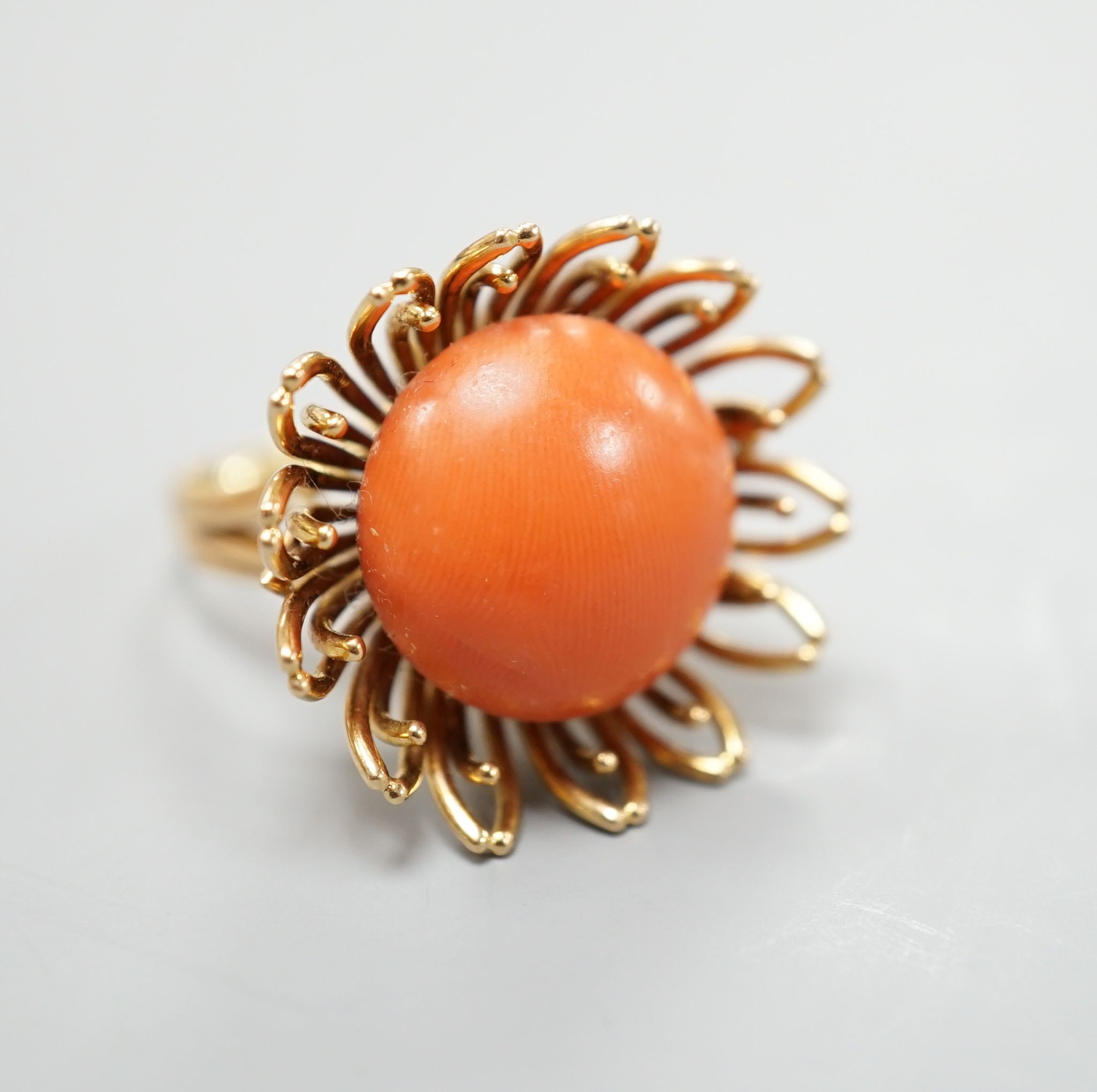 A modern yellow metal and button shaped coral bead set dress ring, size L, gross weight 13.4 grams.